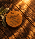 BALANCE GENTLE facial moisturizer in a walnut-lidded tin with sage on dark wood