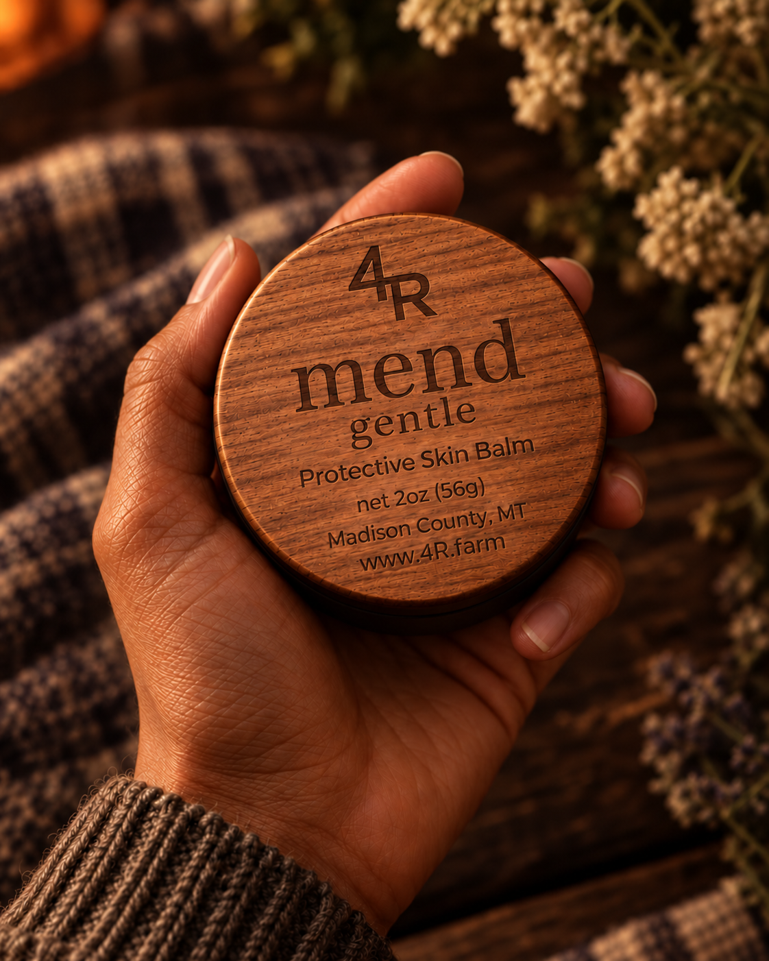 Hand holding MEND GENTLE Protective Skin Balm in its walnut-lidded tin