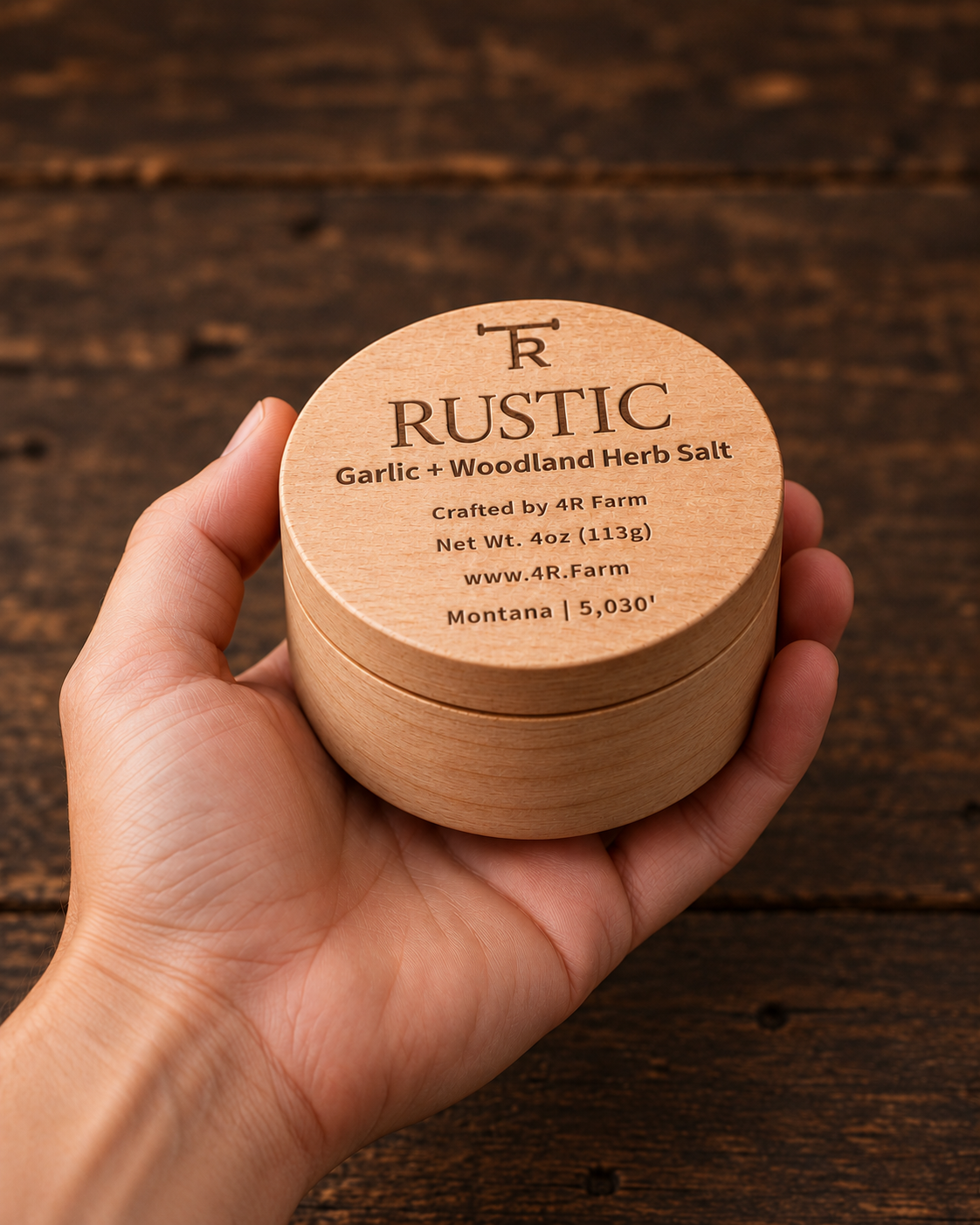 Hand holding a four-ounce RUSTIC salt beechwood tin for scale.