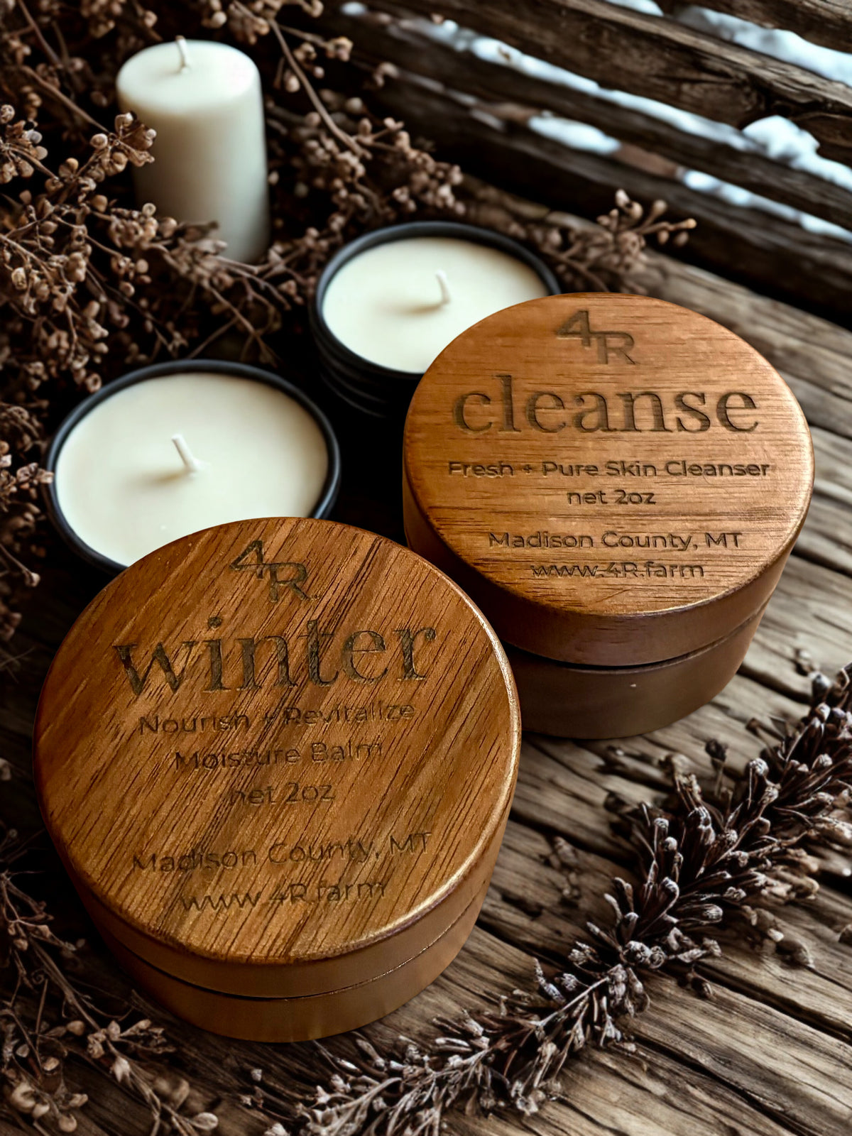 Two wooden containers with candles labeled '4R cleanse' and '4R winter' on a rustic background.