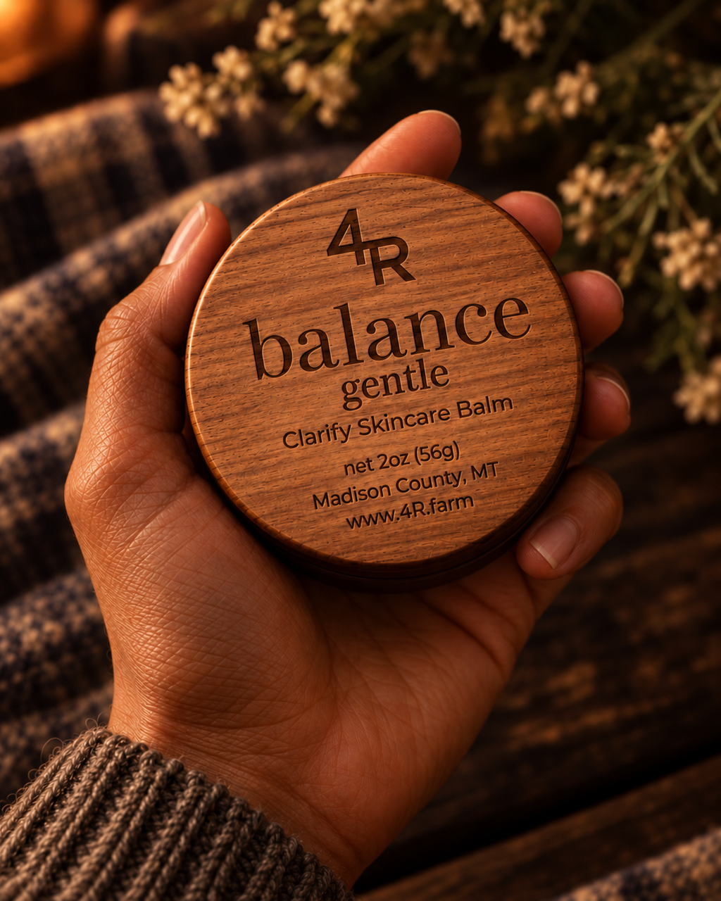 Hand holding BALANCE GENTLE Facial Moisturizer in its walnut-lidded tin