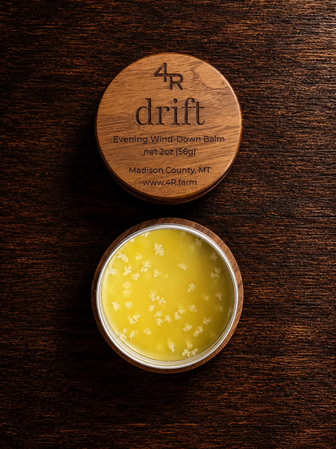 Open DRIFT Evening Wind-Down Balm beside its engraved walnut lid.