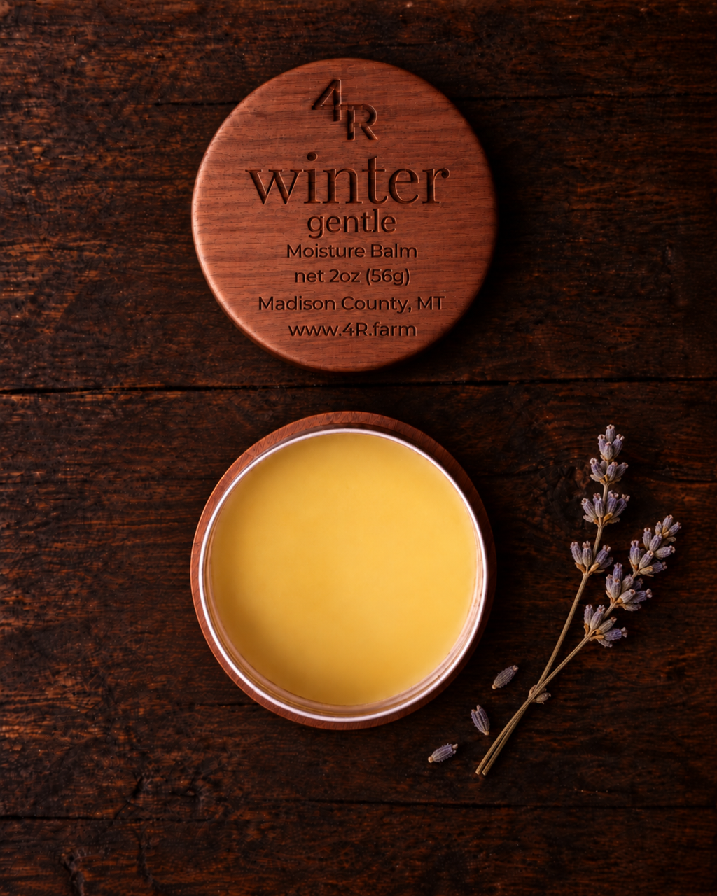 Open WINTER GENTLE Facial Moisturizer beside its walnut lid on dark wood
