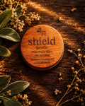 SHIELD GENTLE Soothing Post-Shave Balm in a walnut-lidded tin with botanicals