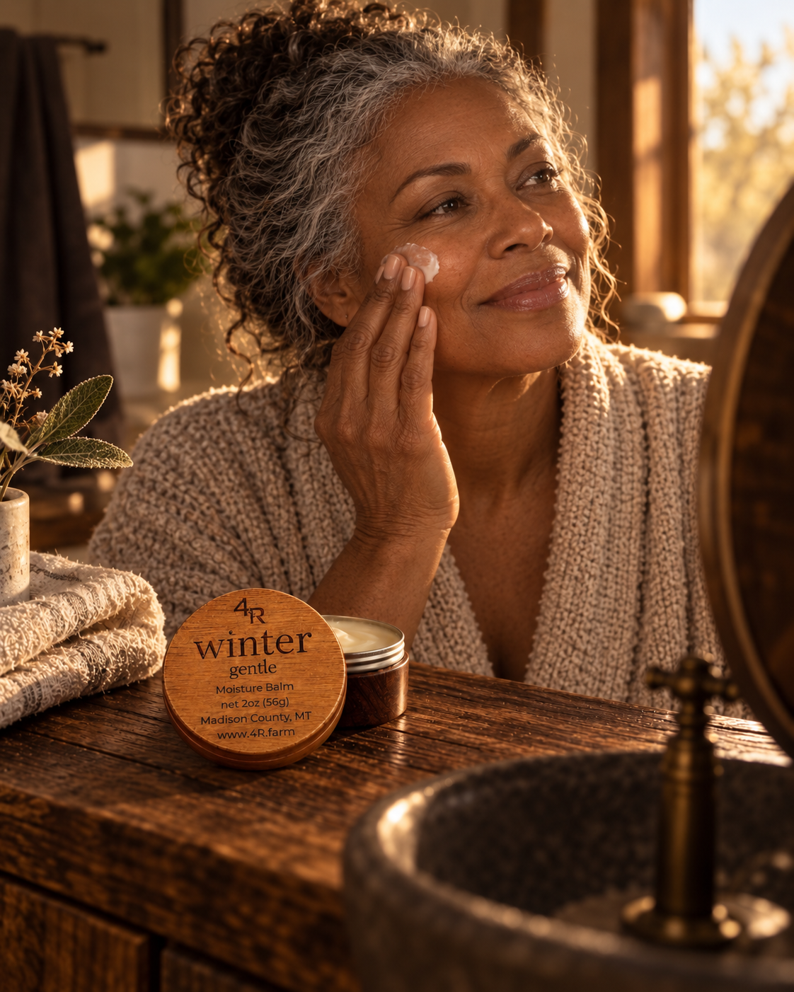 Woman applying WINTER GENTLE Restorative Facial Moisturizer to her face