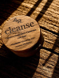 Wooden balm container on a wooden table.
