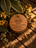 DRIFT GENTLE Evening Wind-Down Balm in a walnut-lidded tin with botanicals on dark wood