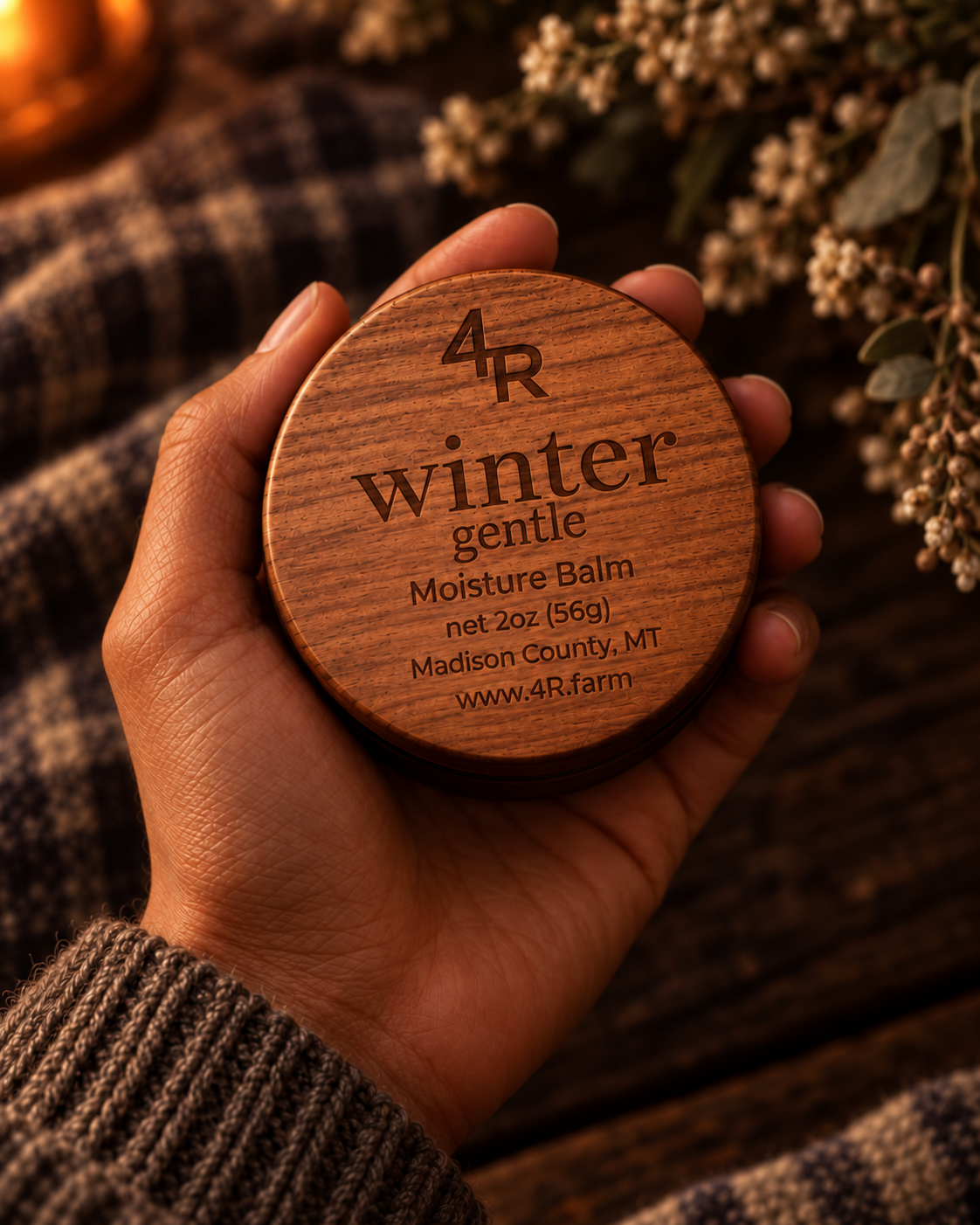 Hand holding WINTER GENTLE Restorative Facial Moisturizer in its walnut-lidded tin