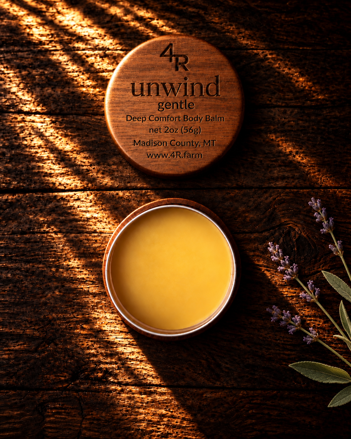 Open UNWIND GENTLE Deep Comfort Body Balm beside its walnut lid on dark wood