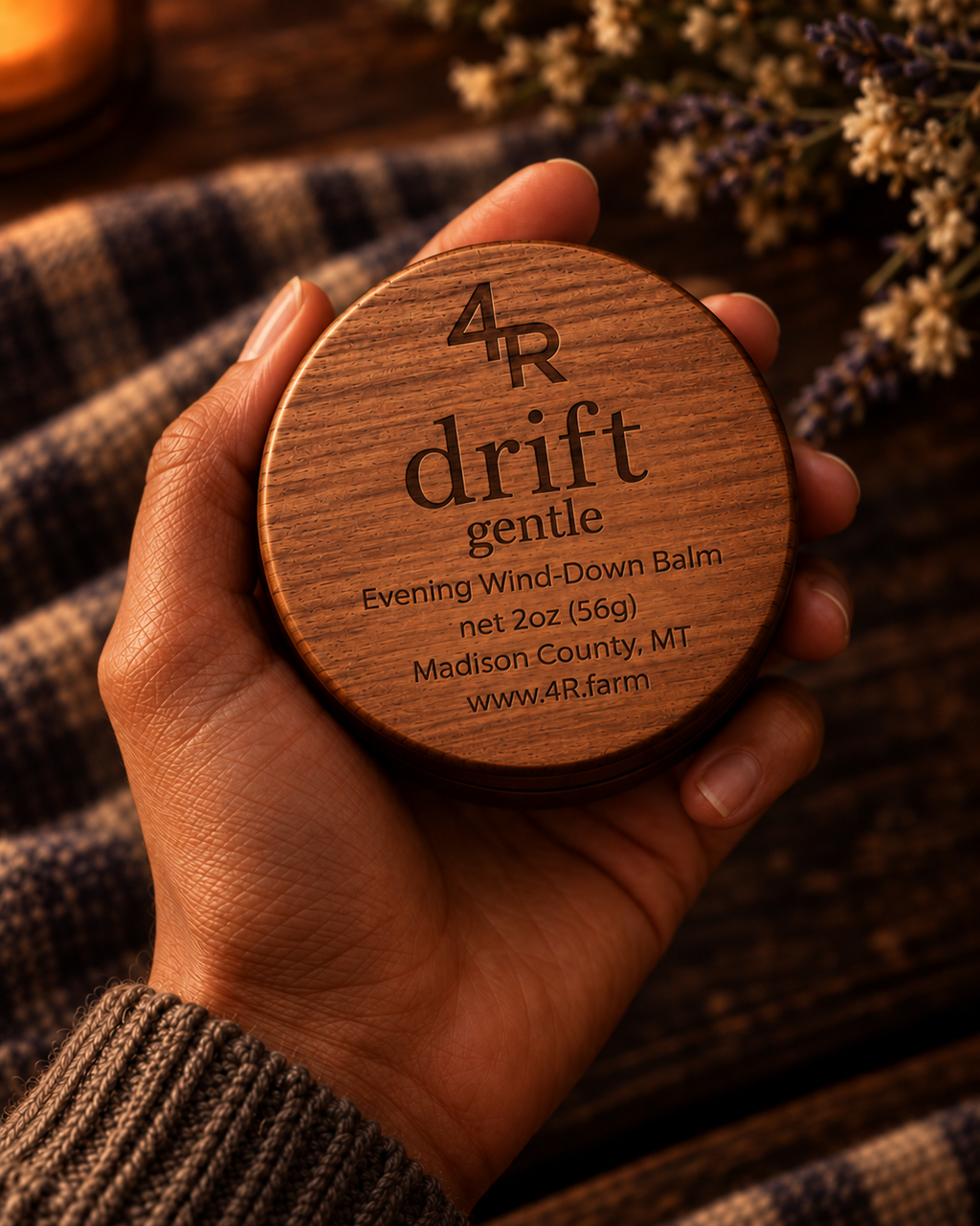 Hand holding DRIFT GENTLE Evening Wind-Down Balm in its walnut-lidded tin