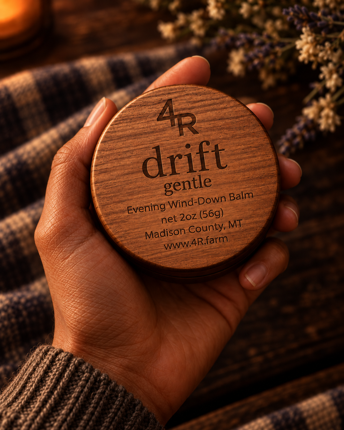 Hand holding DRIFT GENTLE Evening Wind-Down Balm in its walnut-lidded tin
