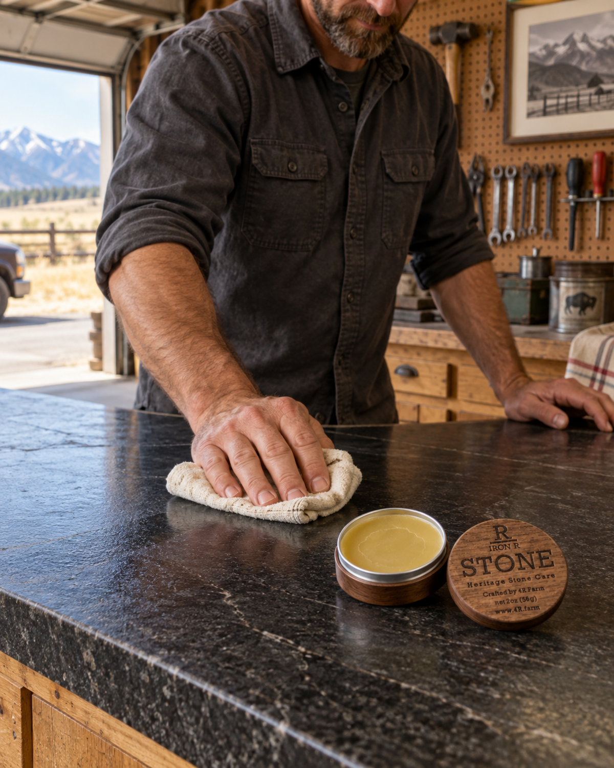 Man polishing a dark granite work surface with IRON R STONE nearby.
