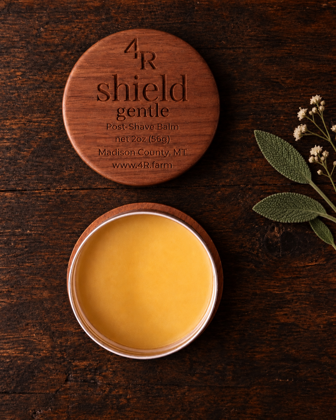 Open SHIELD GENTLE Soothing Post-Shave Balm beside its walnut lid on dark wood