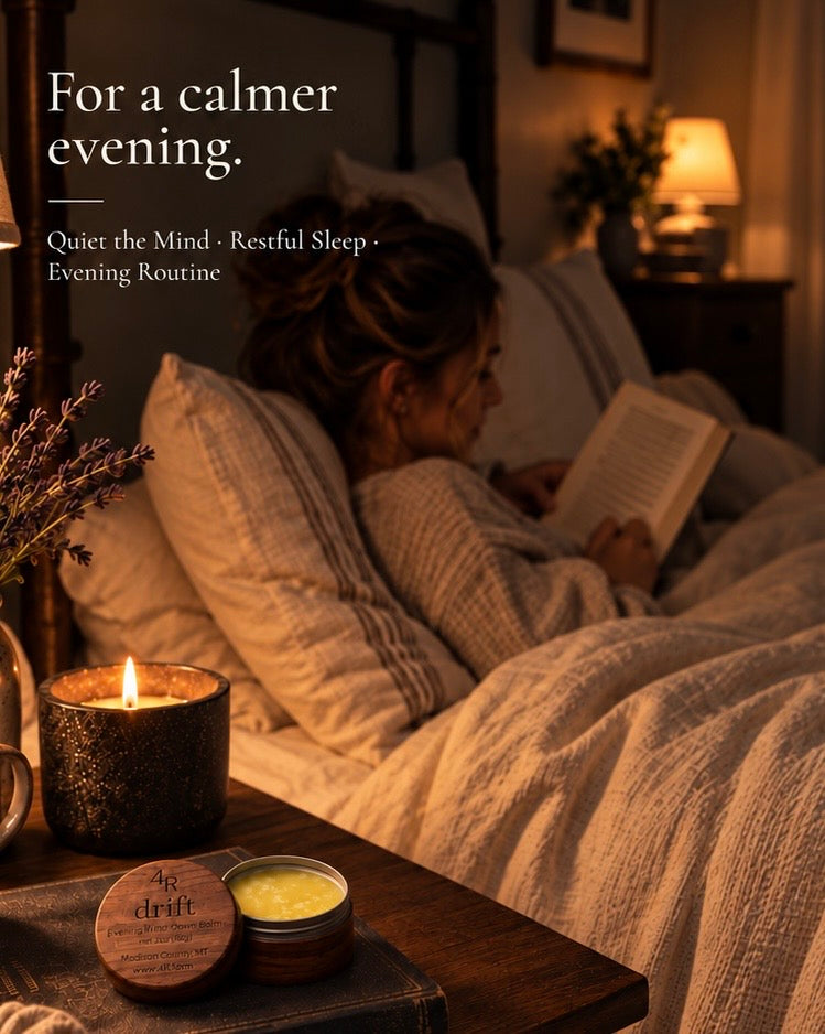 Woman reading in bed beside a candle and DRIFT balm, with the words “For a calmer evening.”
