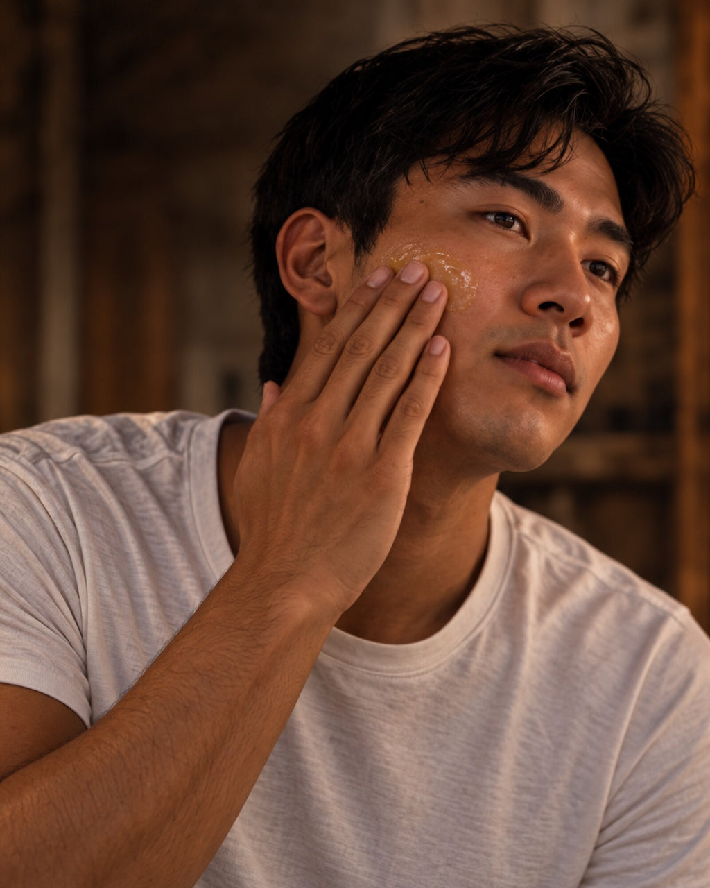 Man applying BALANCE skincare balm to his cheek.
