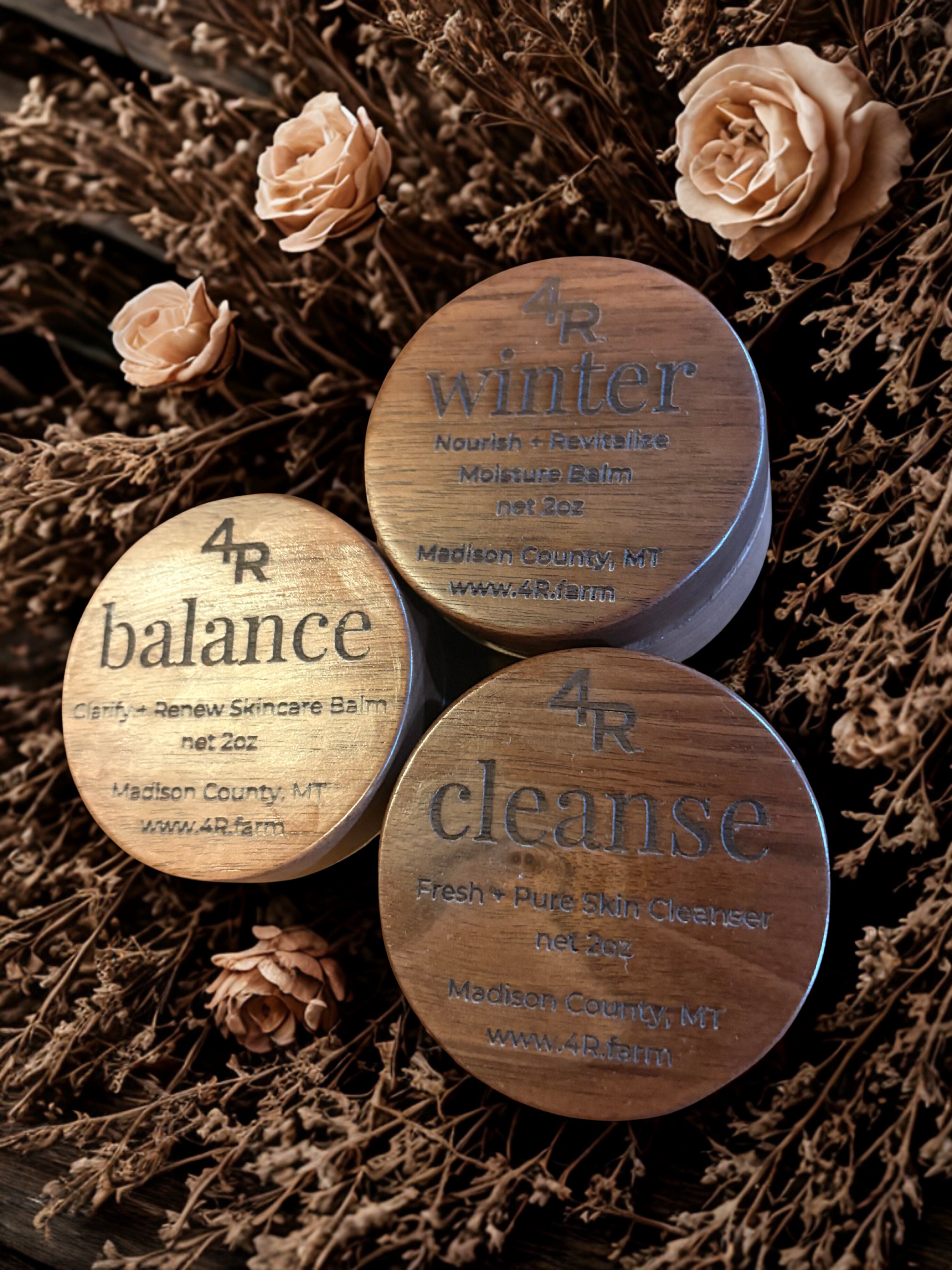 Three wooden containers labeled '4R balance', '4R winter', and '4R cleanse' on a floral background.