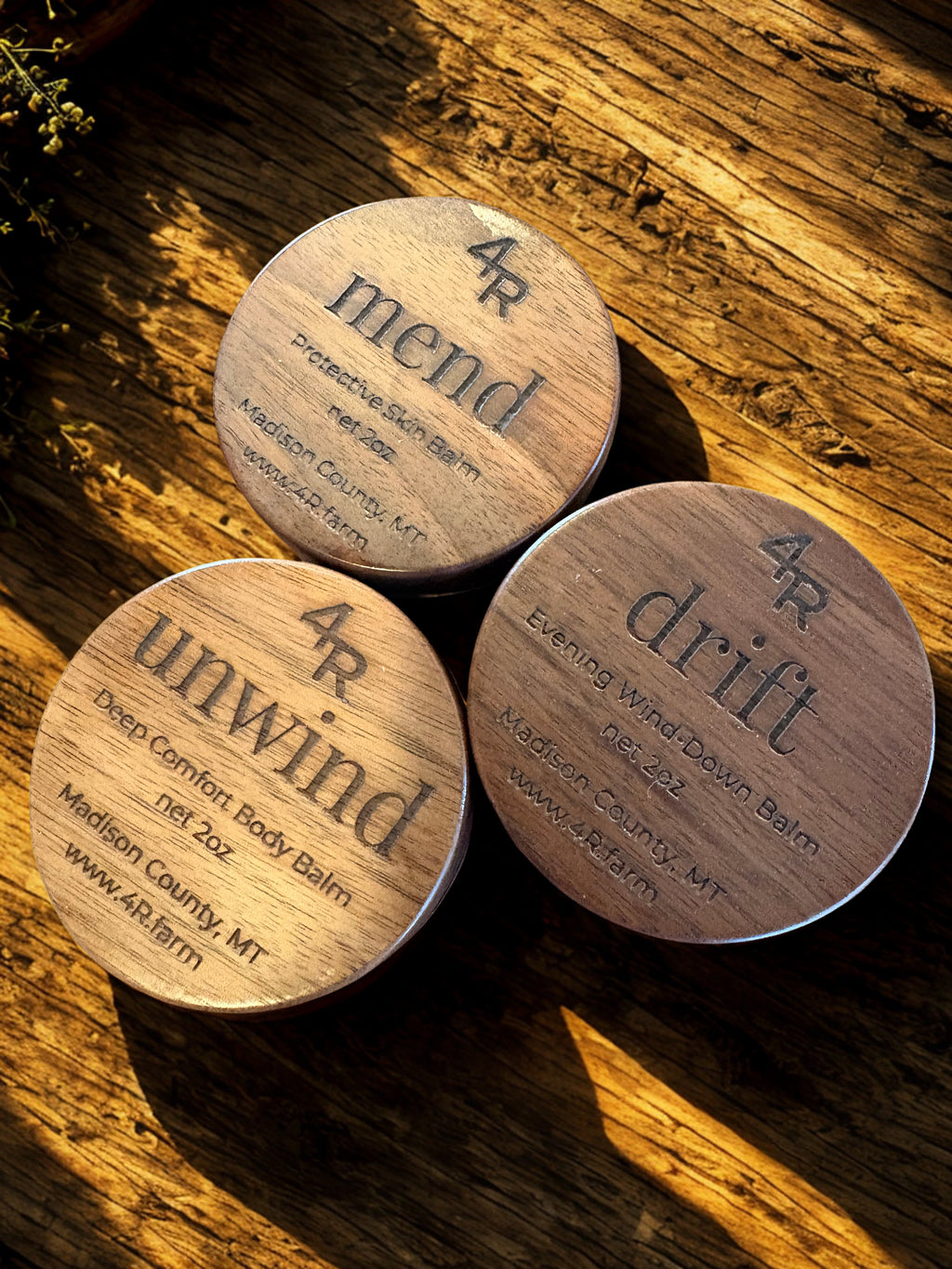 Three wooden containers labeled '4R mend', '4R drift', and '4R unwind' on a wooden surface.