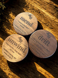 Three wooden containers labeled '4R mend', '4R drift', and '4R unwind' on a wooden surface.