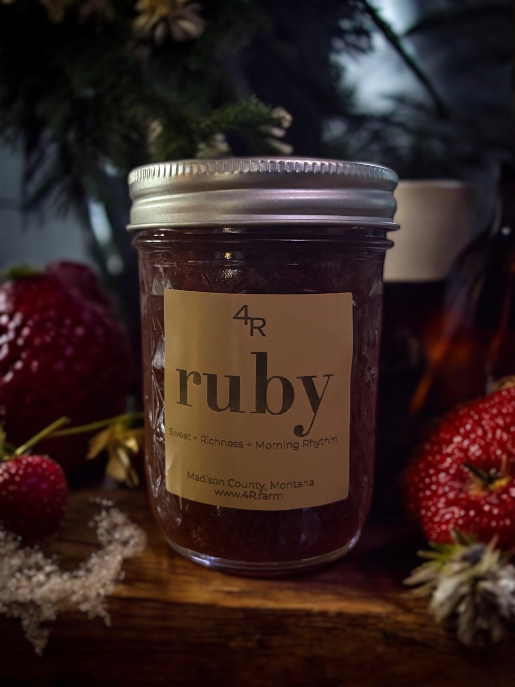 jar of 4R strawberry balsamic jam surrounded by botanical and strawberry accents