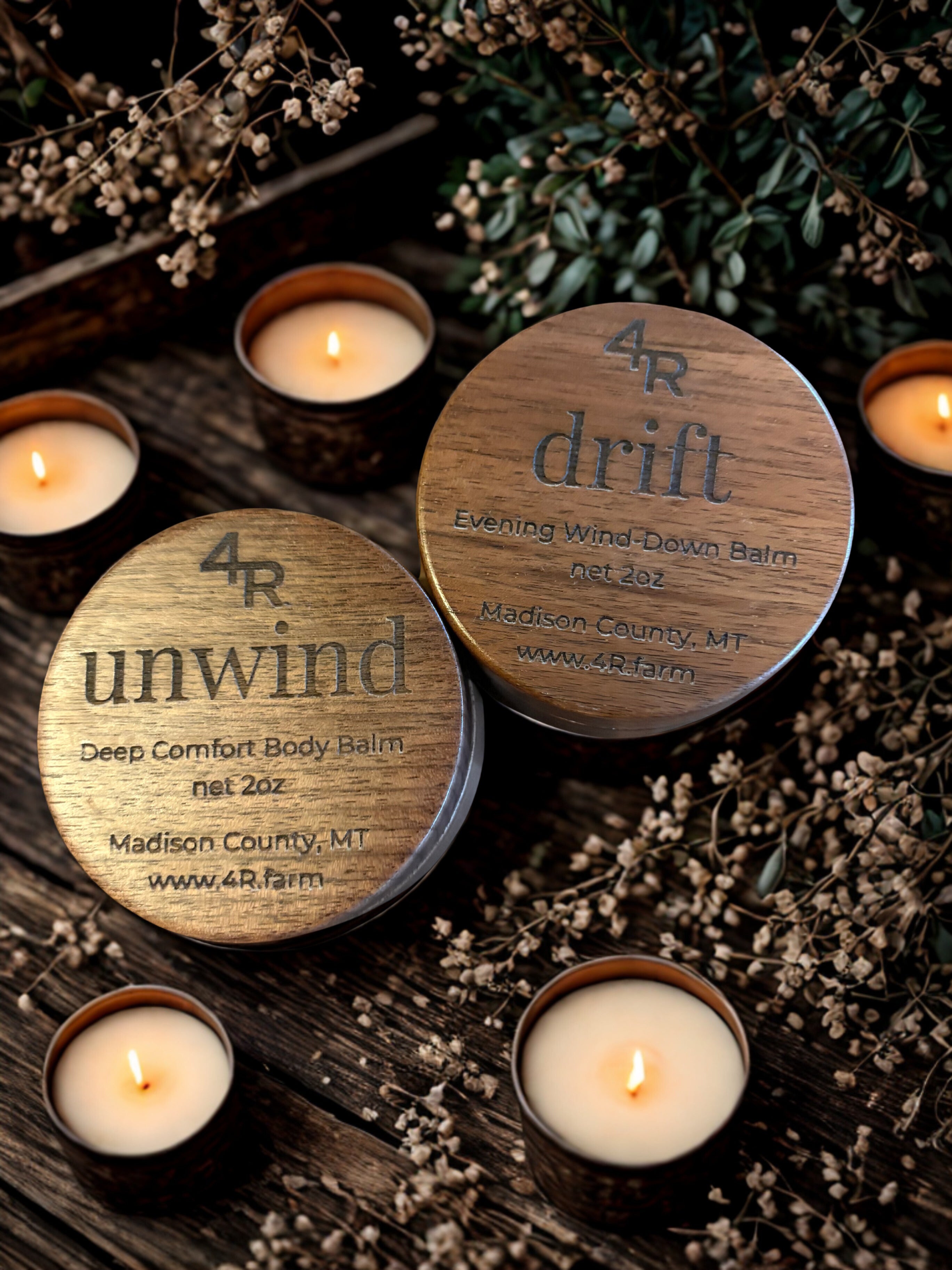 Wooden containers labeled '4R unwind' and '4R drift' with lit candles on a wooden surface.
