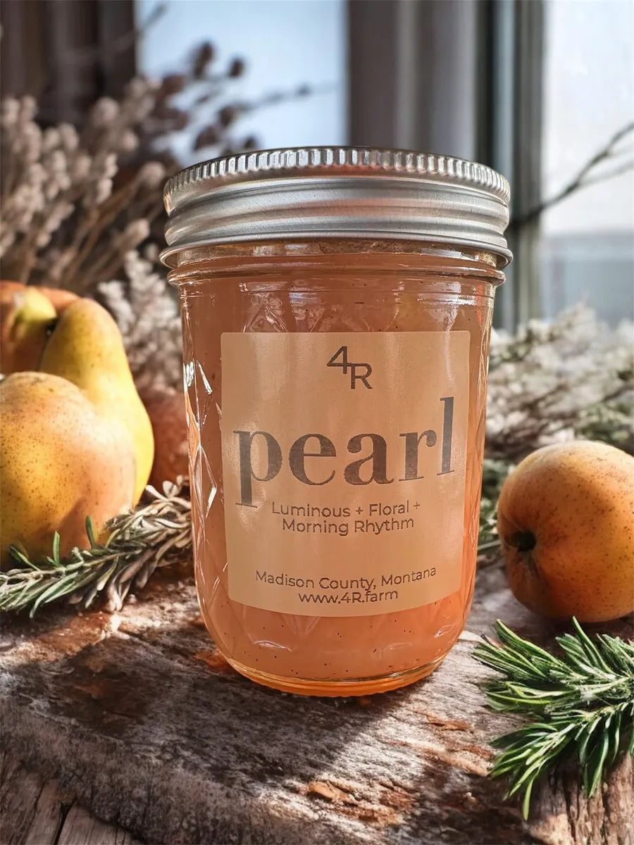 Jar of 'pearl' jam with pears and rosemary on a wooden surface