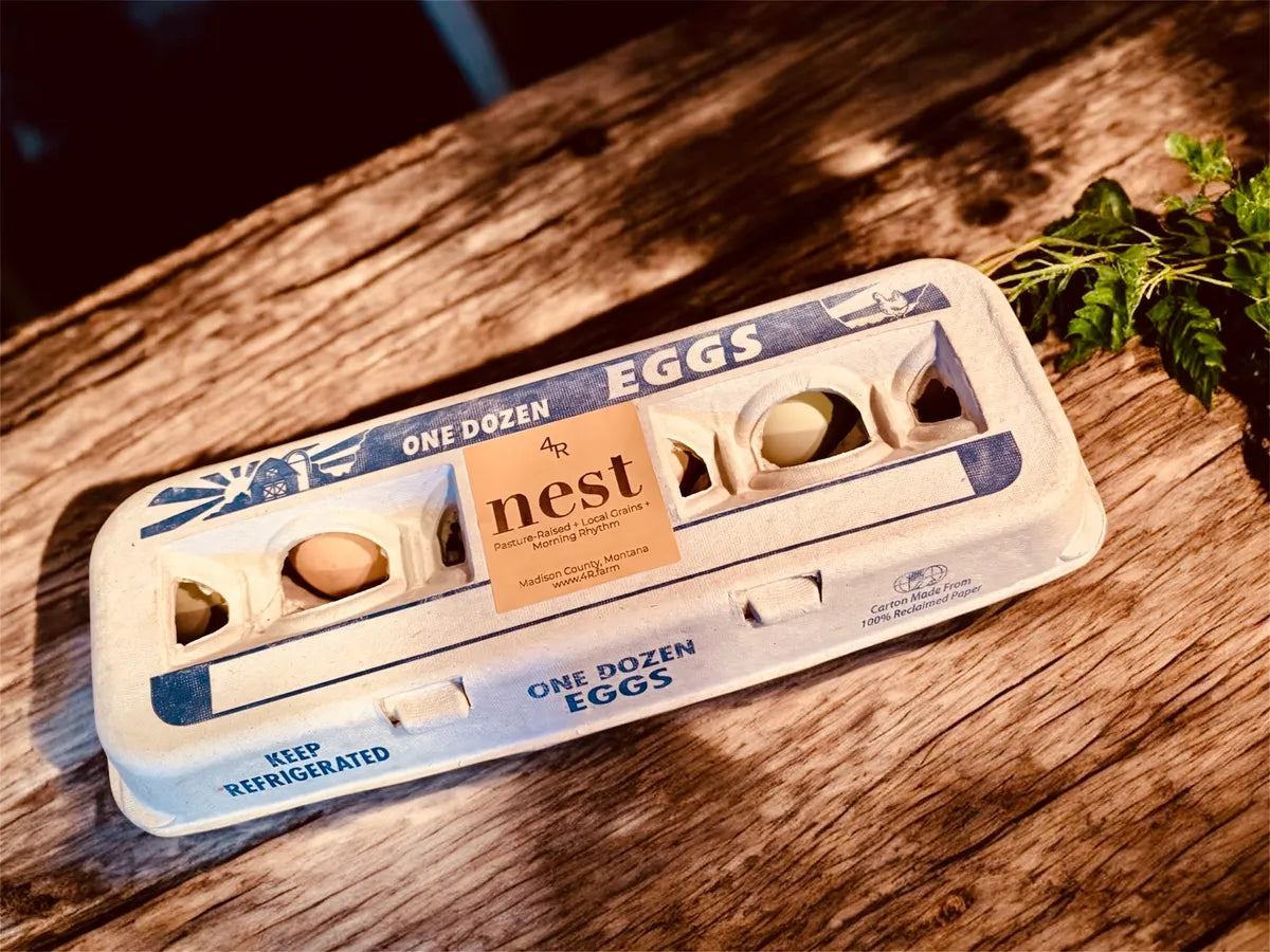Egg carton with 'The Nest' label on a wooden surface